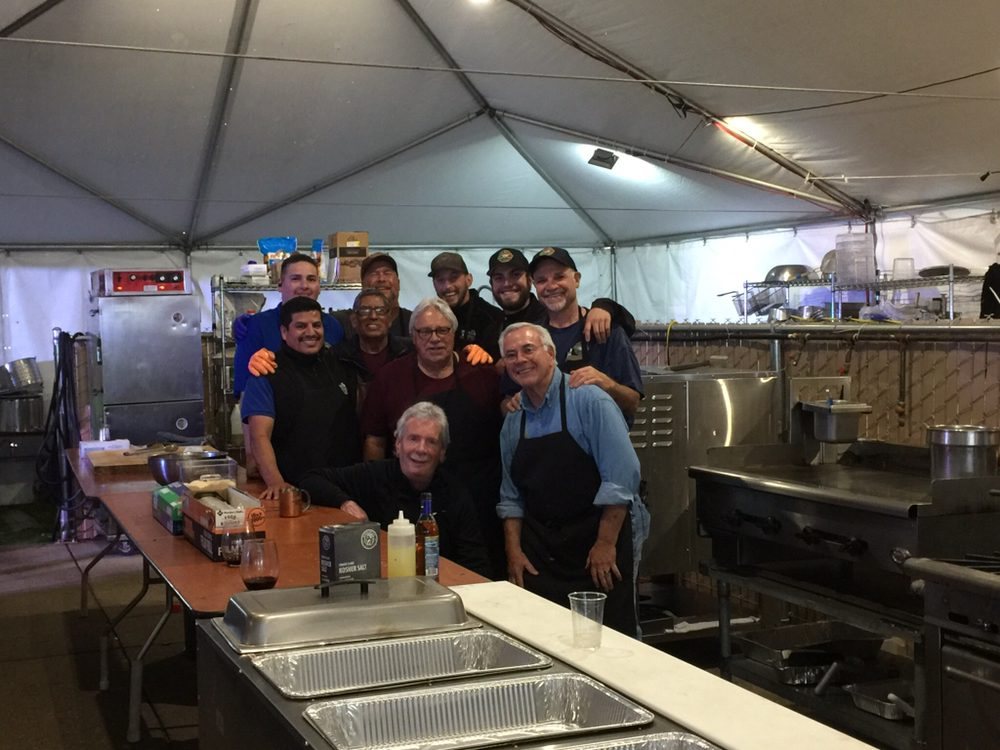 The Paisan&rsquo;s catering crew gathered in the kitchen tent at an event