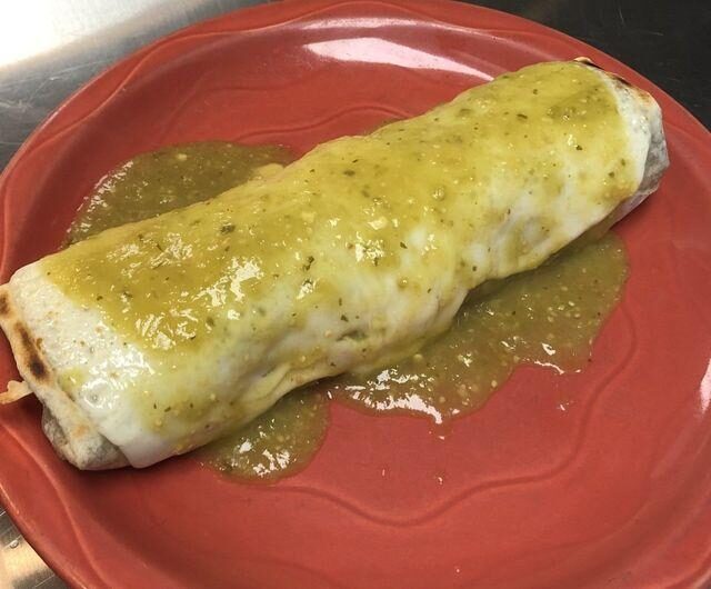 The wet burrito, smothered in green salsa