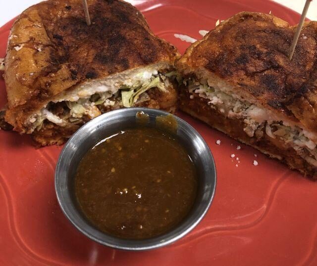 The Ultimate tri-tip sandwich with its cup of au jus