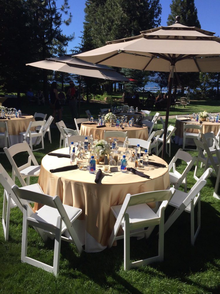 Umbrella-shaded rounds set for a garden celebration