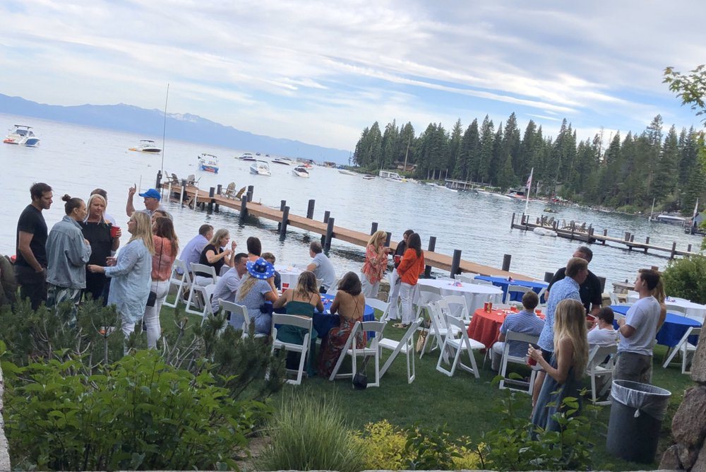 Guests gathered for a pier-side reception on the lake