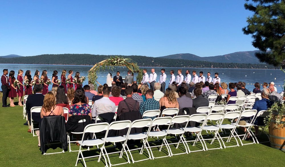 A lakefront wedding ceremony at Lake Tahoe, the full wedding party at the water