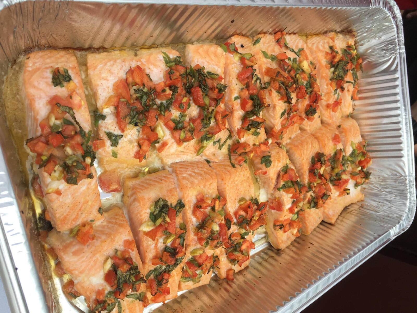 A hot catering tray of baked salmon